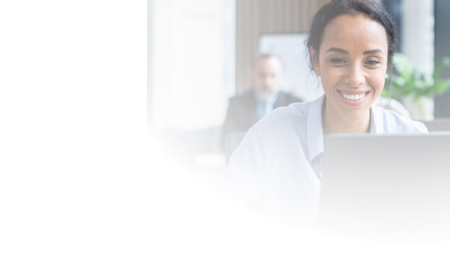 a smiling woman sitting in an office, looking at triplog's web app