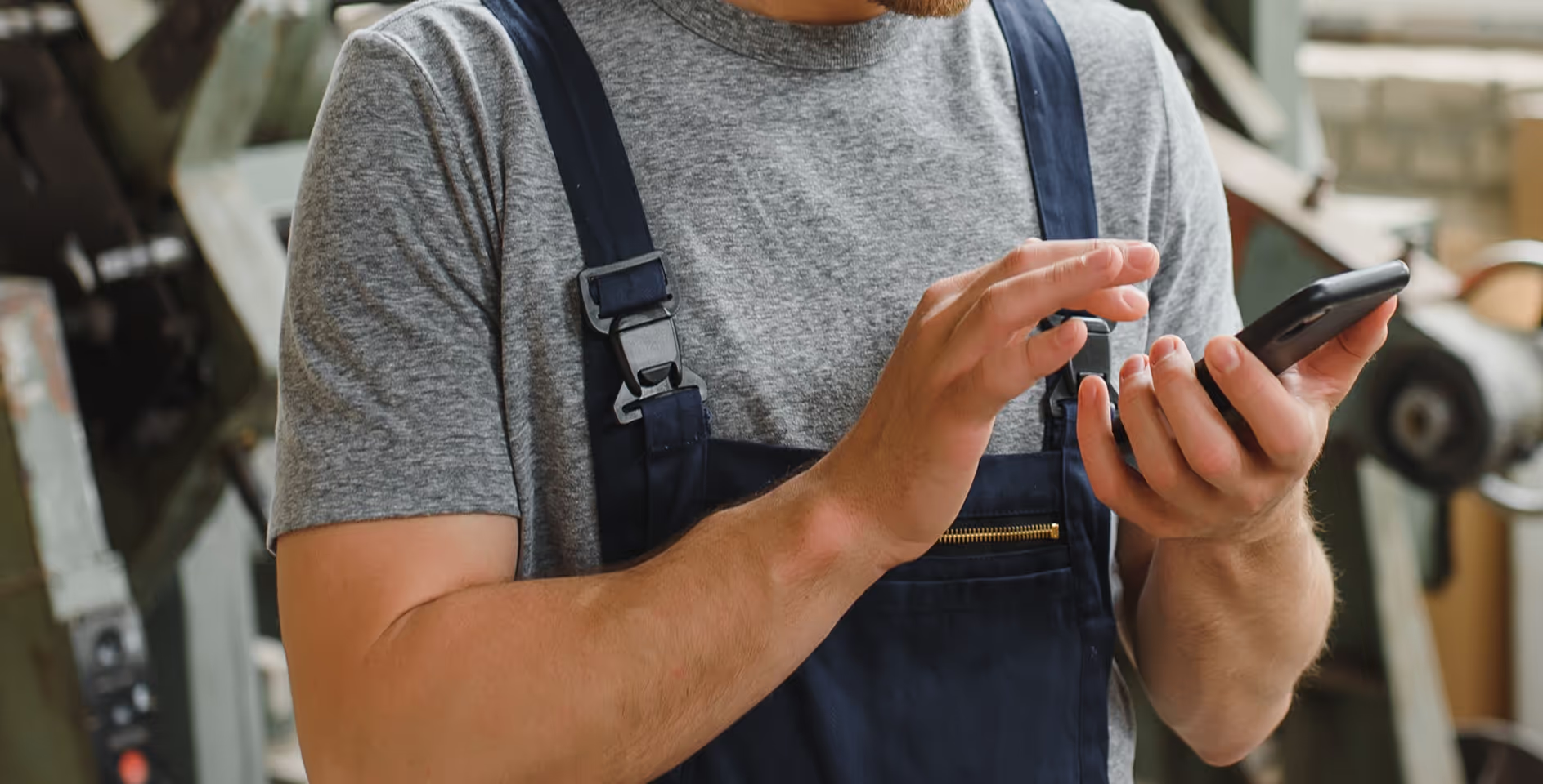a worker holding their phone interacting with TripLog