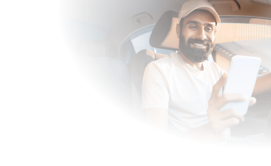 hero banner image showing a smiling man looking at TripLog's mileage tracker on his phone