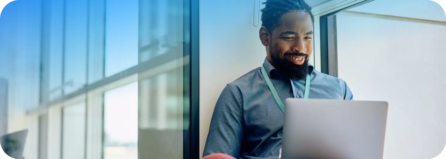 Business manager reviewing employee mileage reports on laptop