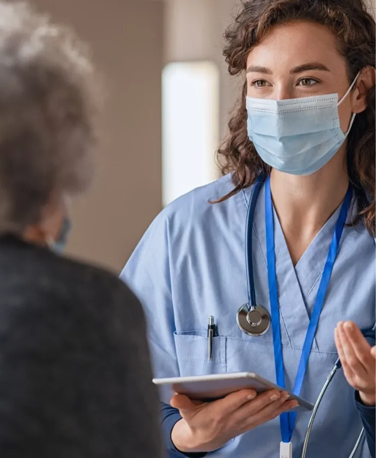 Healthcare professional speaking with a patient