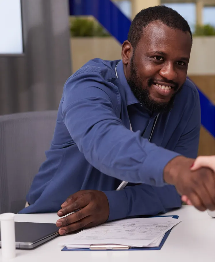 Sales professional shaking hands with a client