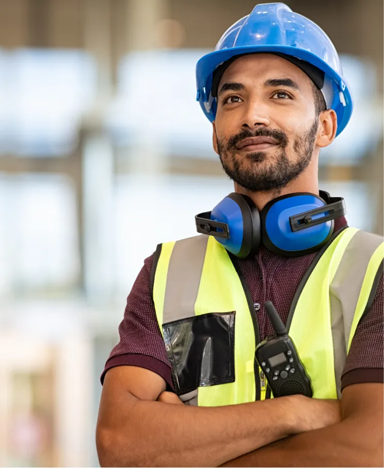 Construction worker wearing a hard hat and safety vest