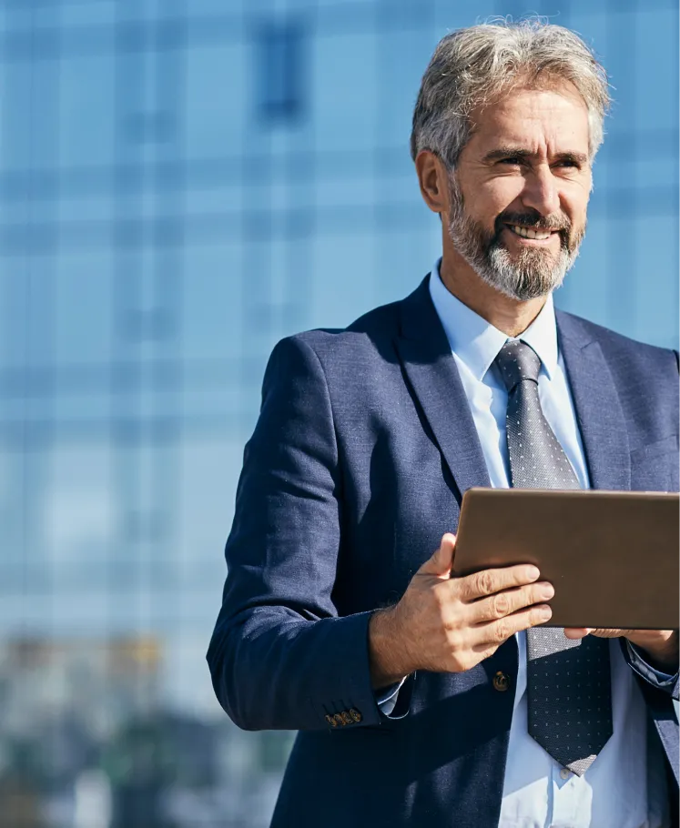 Business professional holding tablet outside an office