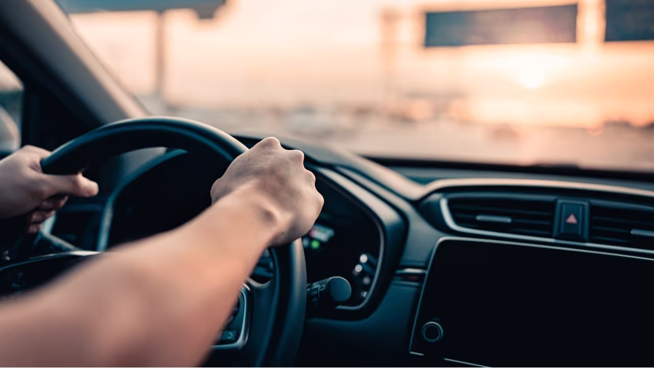uber driver driving on the road|uber driver sitting in car holding phone|cars driving on the road in a big city they might be uber drivers