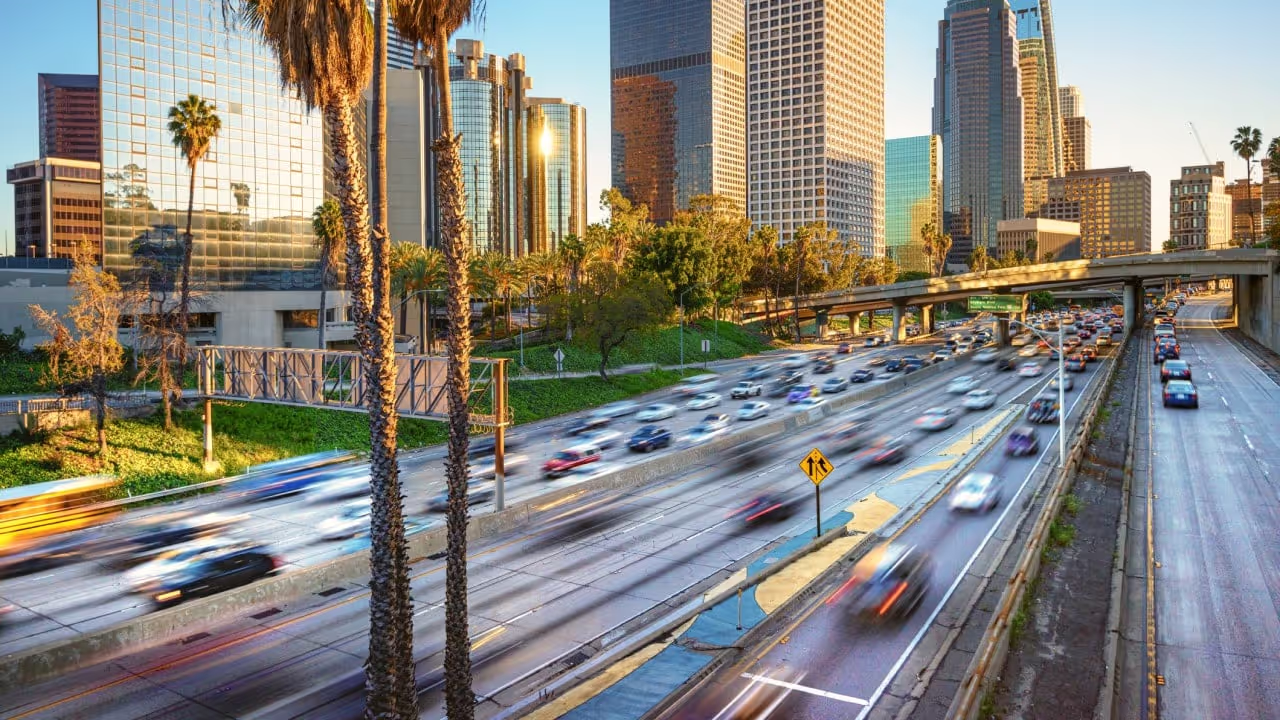 cars on road, some might be mobile employees|business-person-working-at-table-maybe-handling-mileage-expenses