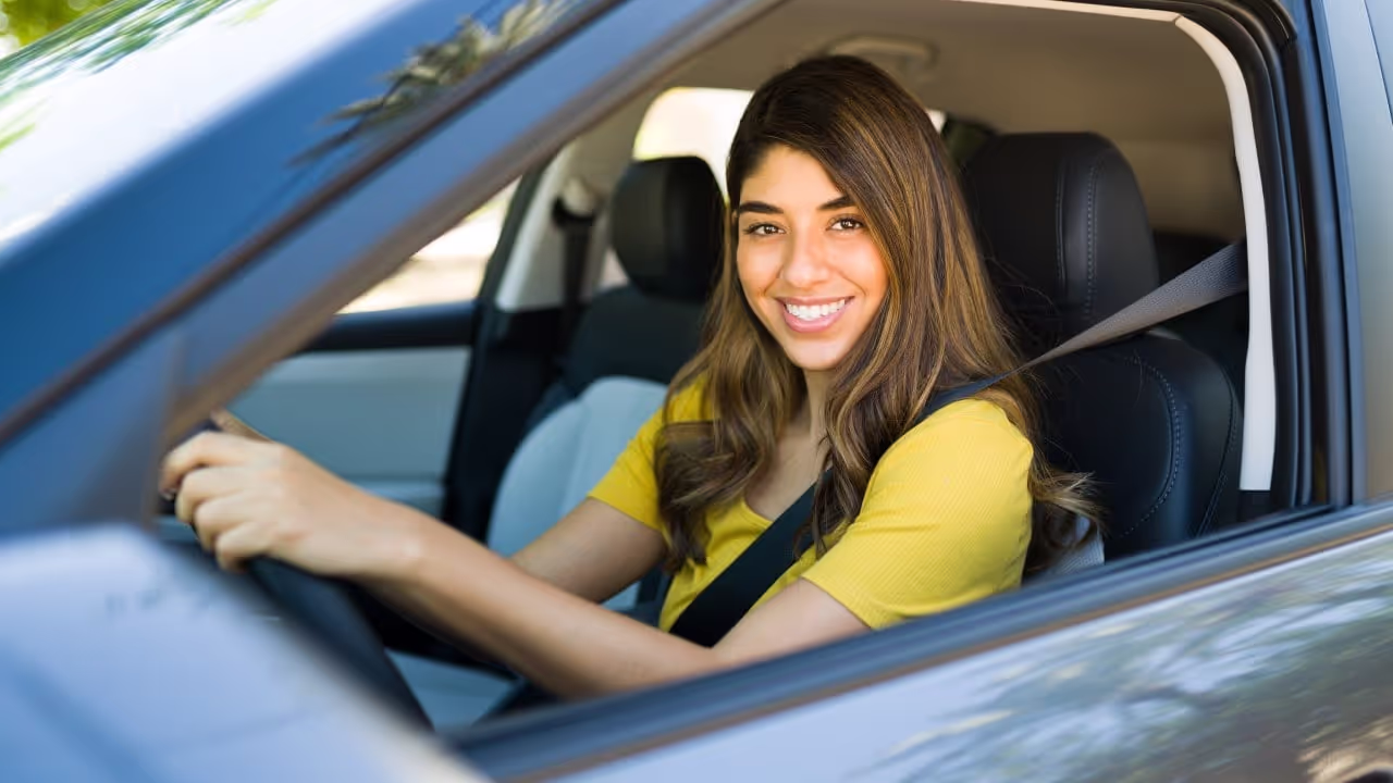 woman sitting in car might be an uber pro driver|cars driving in city might be an uber car|