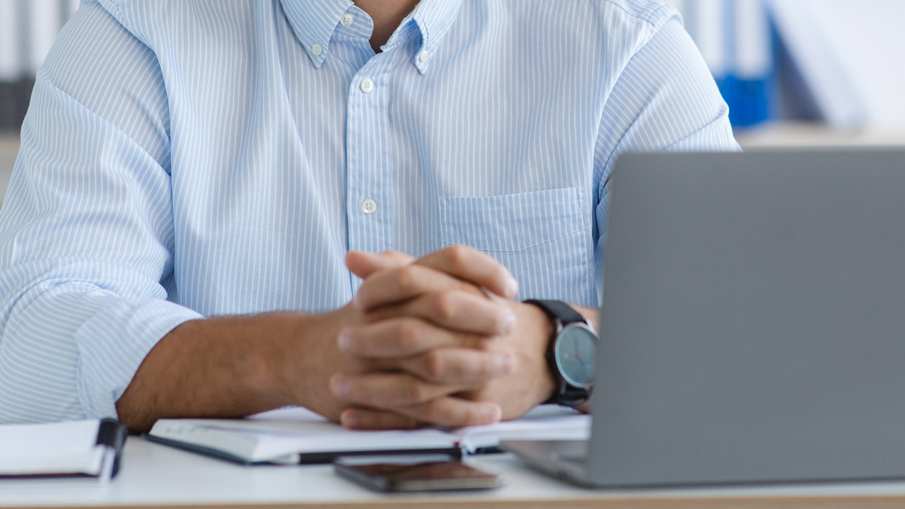 accountable plan explained article header image man sitting at computer
