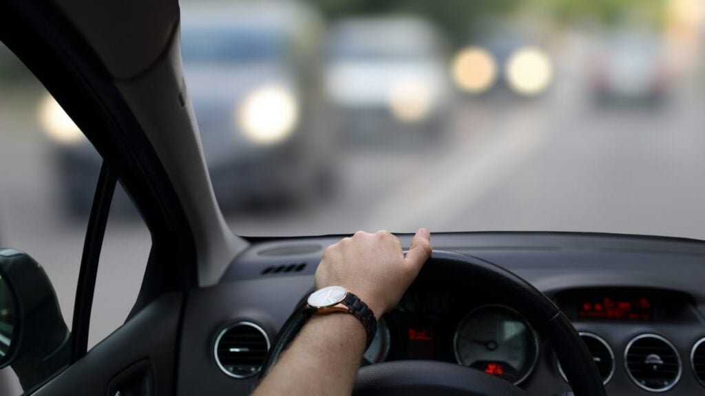 person driving their car as it depreciates