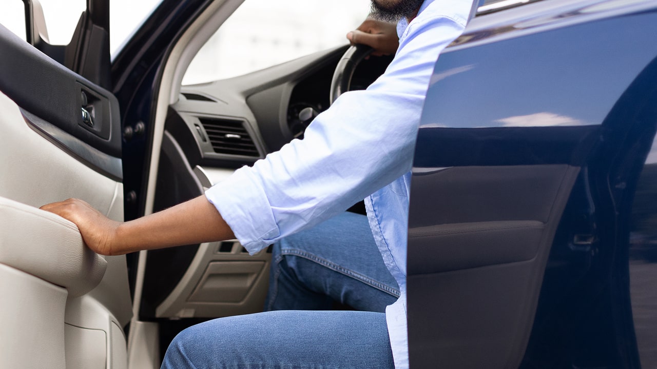 lyft driver opening car door and exiting