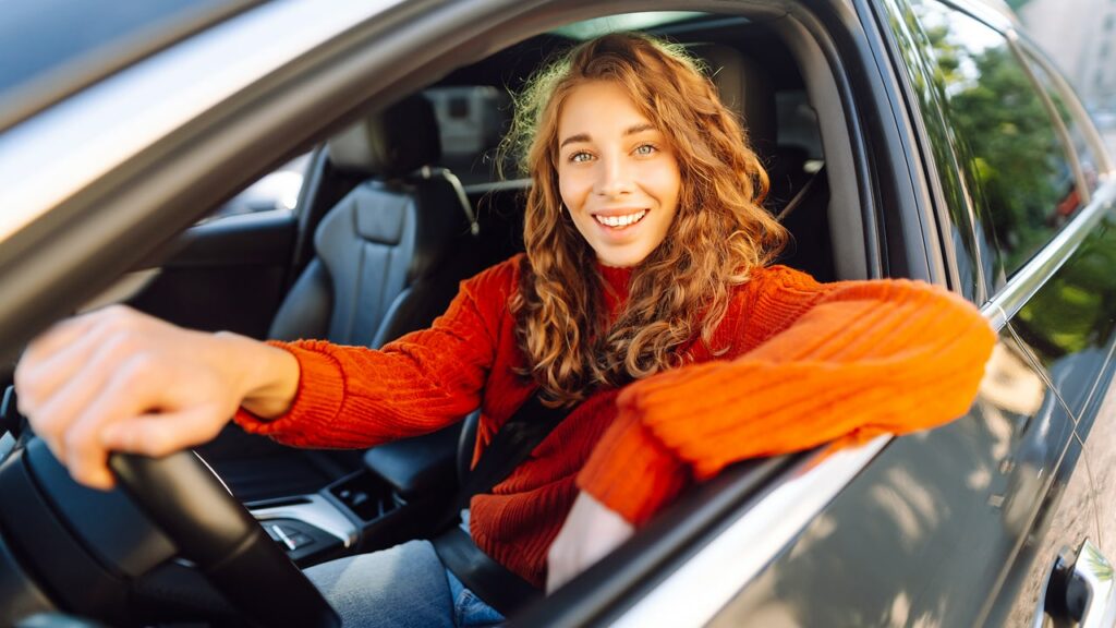 person driving their car tracking mileage using irs mileage rate