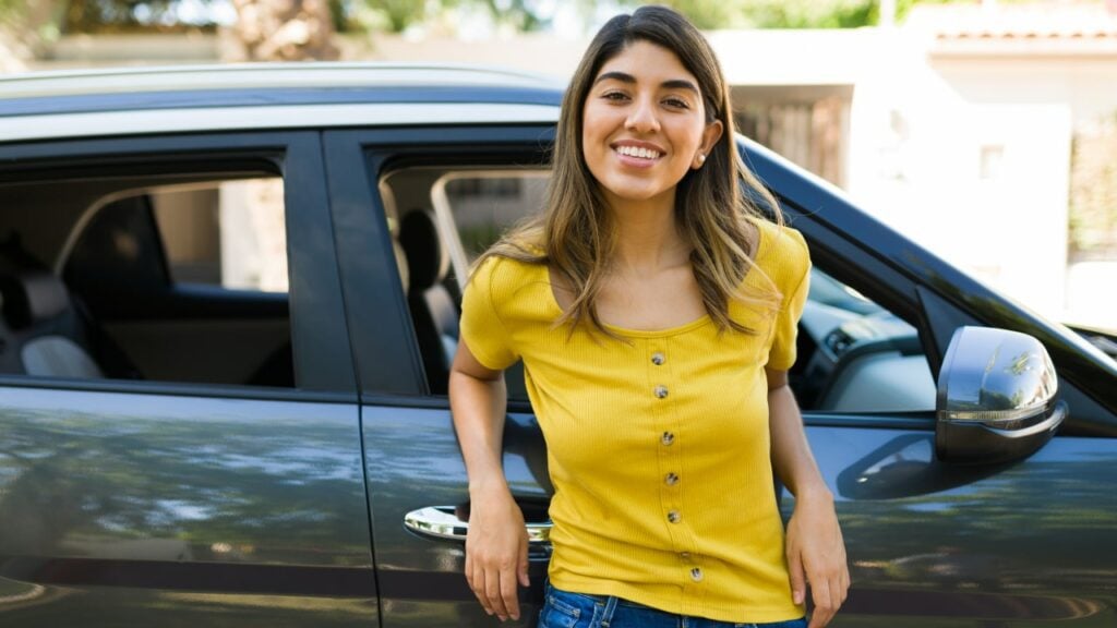 woman standing near her car