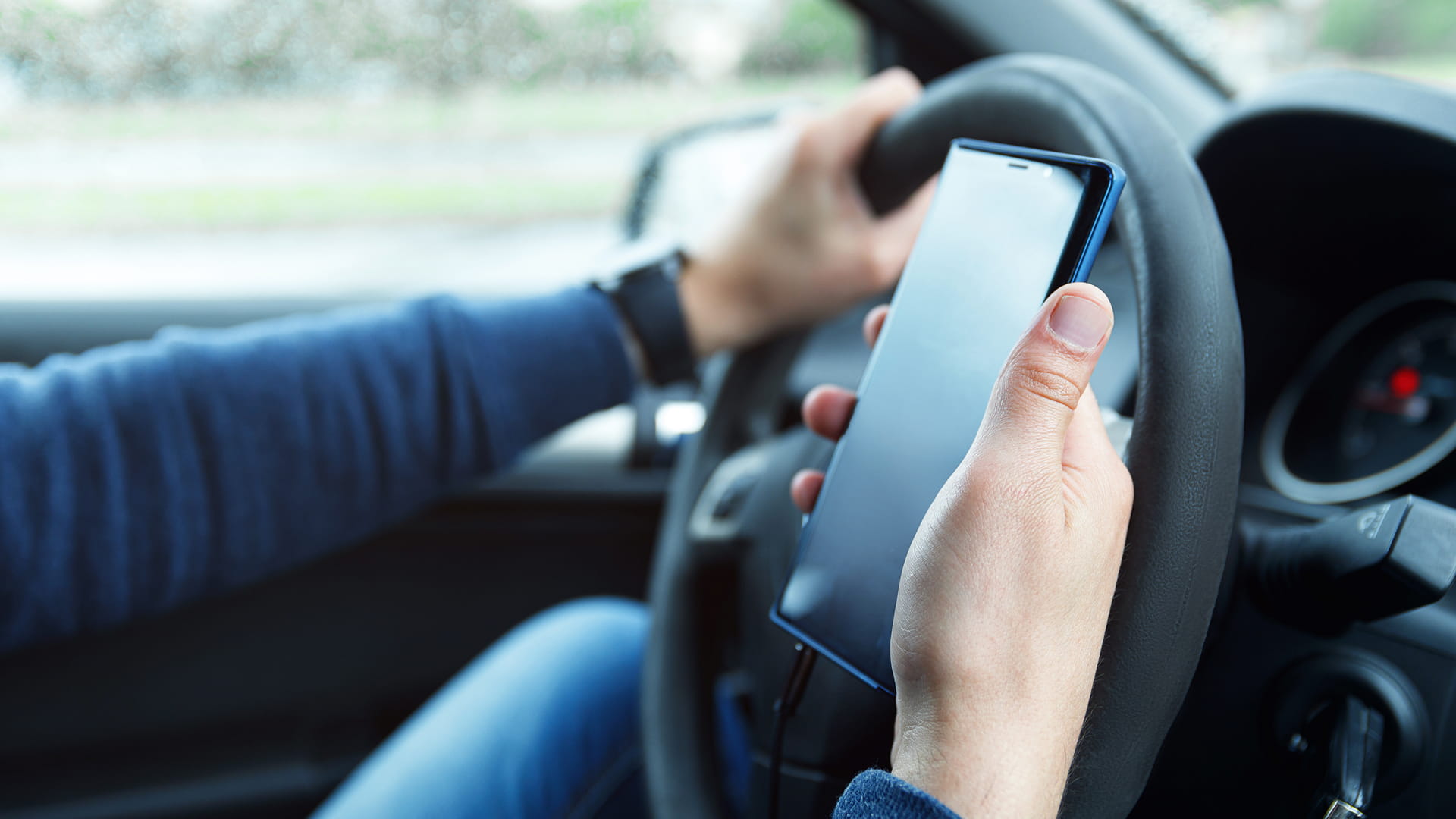 rideshare driver looking at their phone