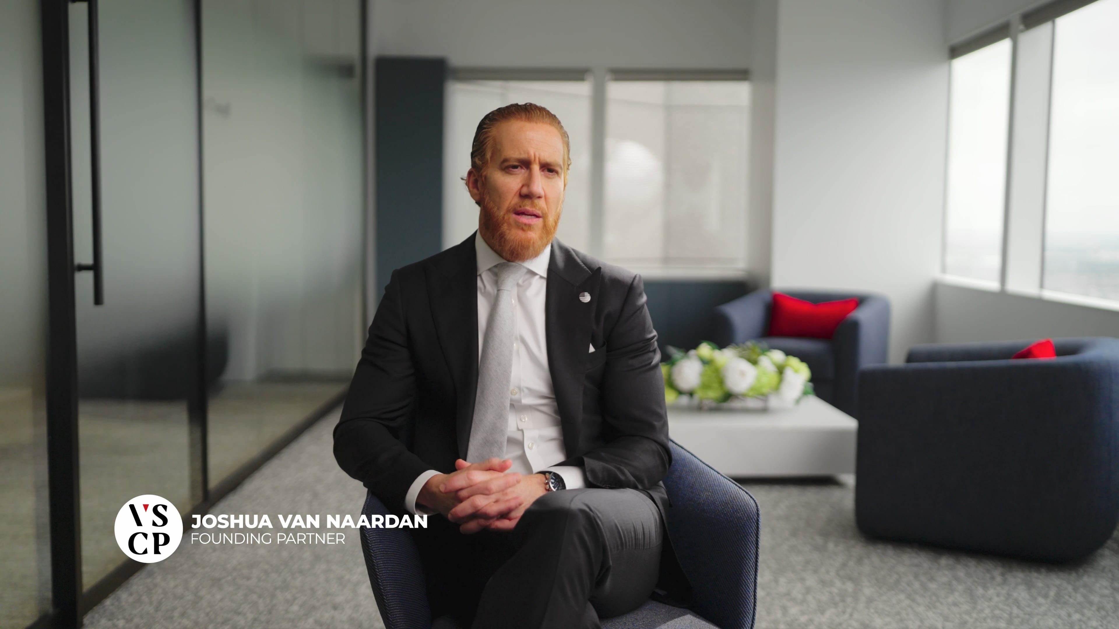 Joshua van Ceo of VSCPLAW on a chair in an interview 