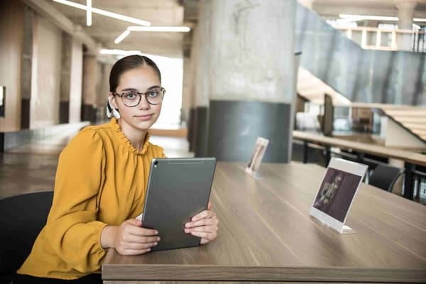 A woman taking notes on an iPad