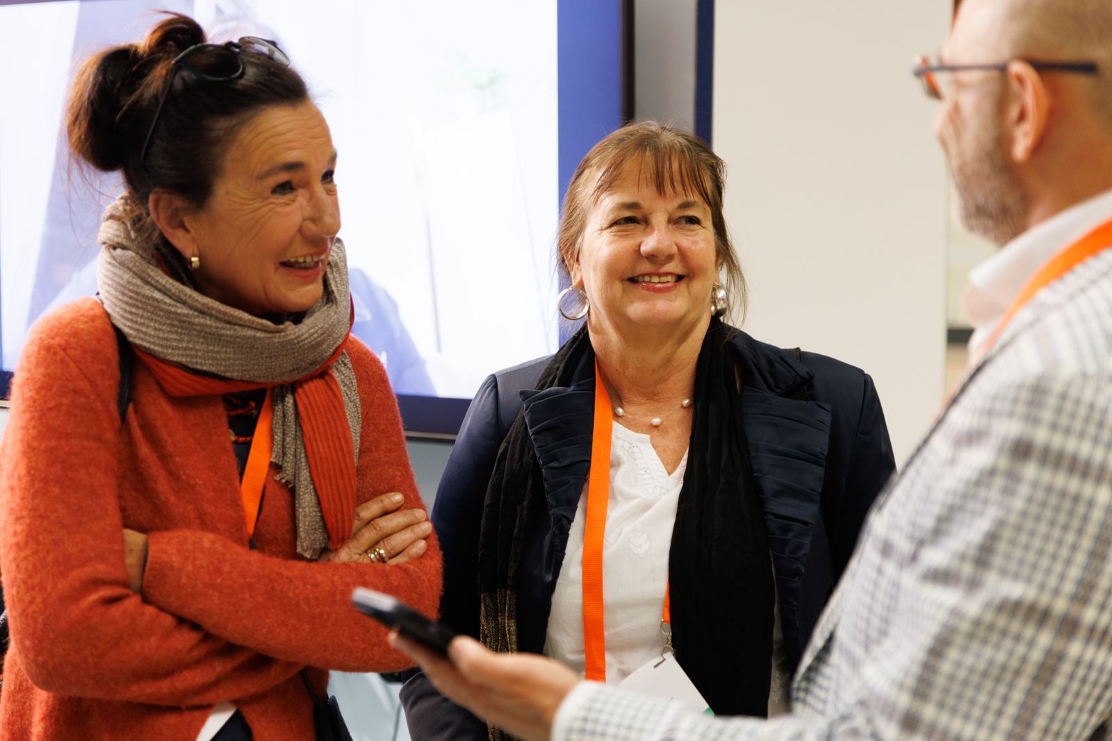 Practitioners sharing a moment of joy at the booth