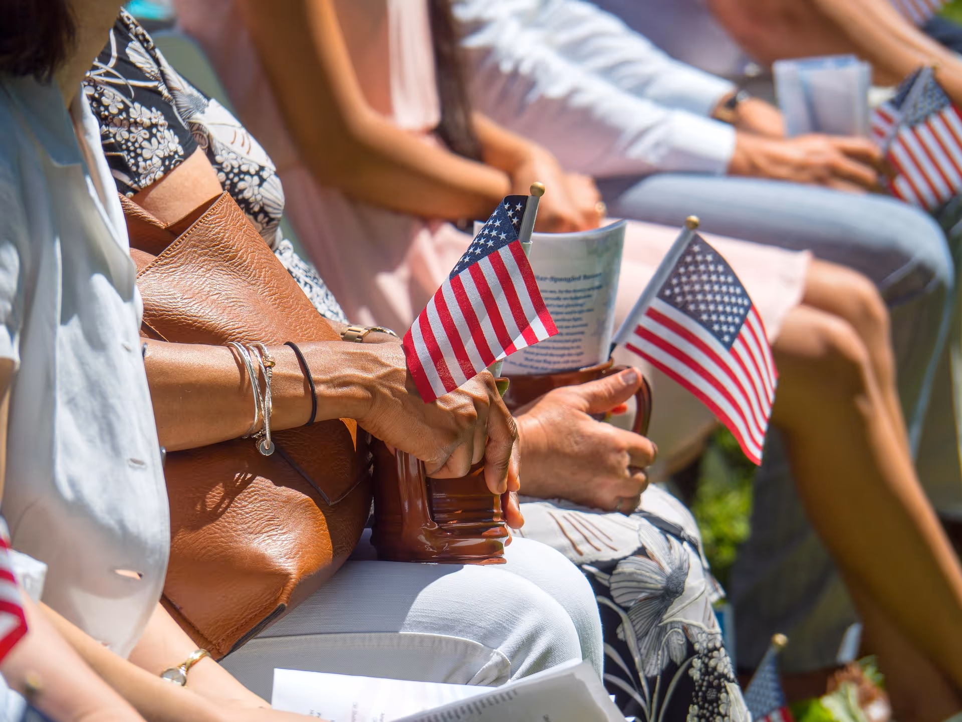 Women holding an American flag with a Bible