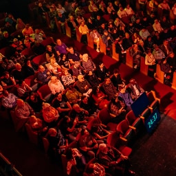 An auditorium filled with people hungry for God’s presence, joining together in prayer for revival and renewal.
