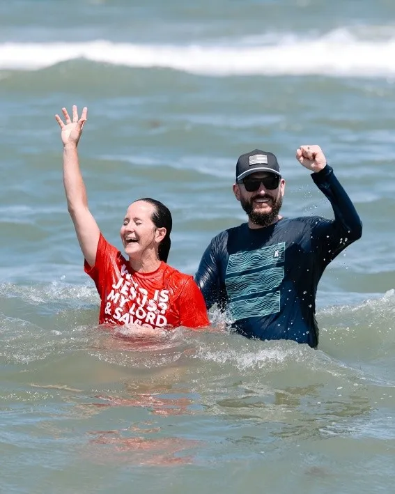 Mass baptism in the Atlantic Ocean with hundreds of people from a Florida church during a revival gathering