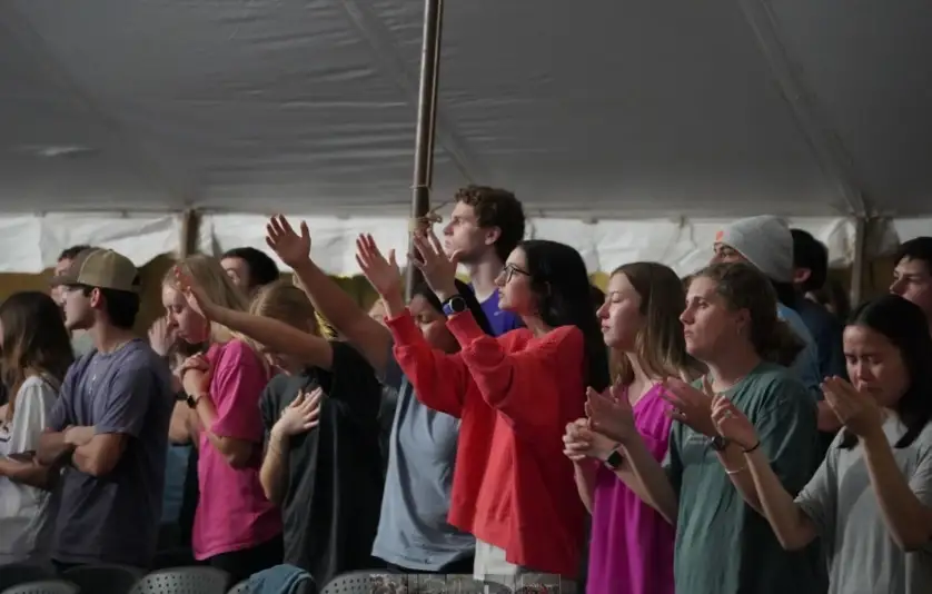 College students gathered at a Texas outdoor tent revival with 80 responding to Christ at UMHB