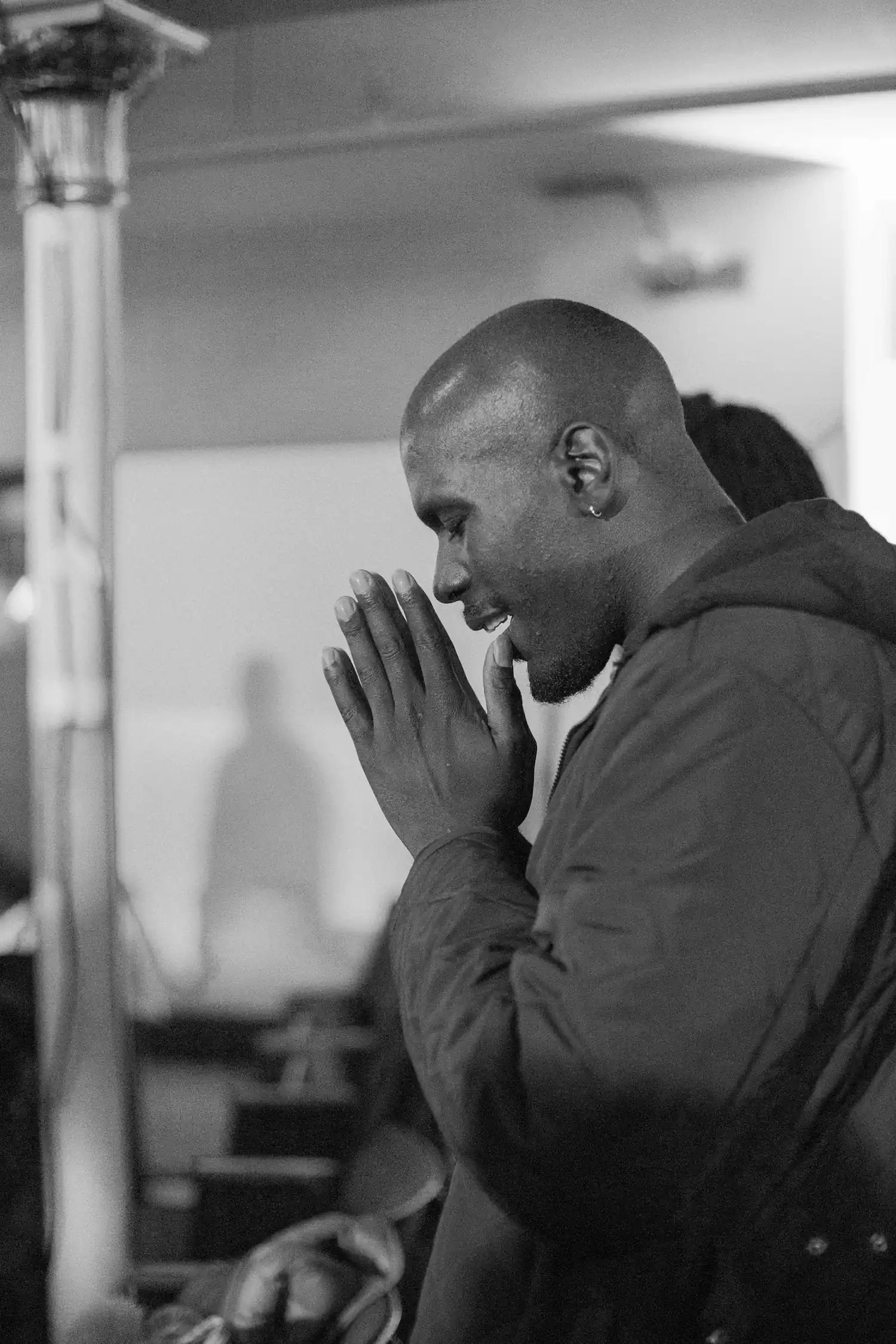 Man praying with hands clasped at AWAKE America Boston rally