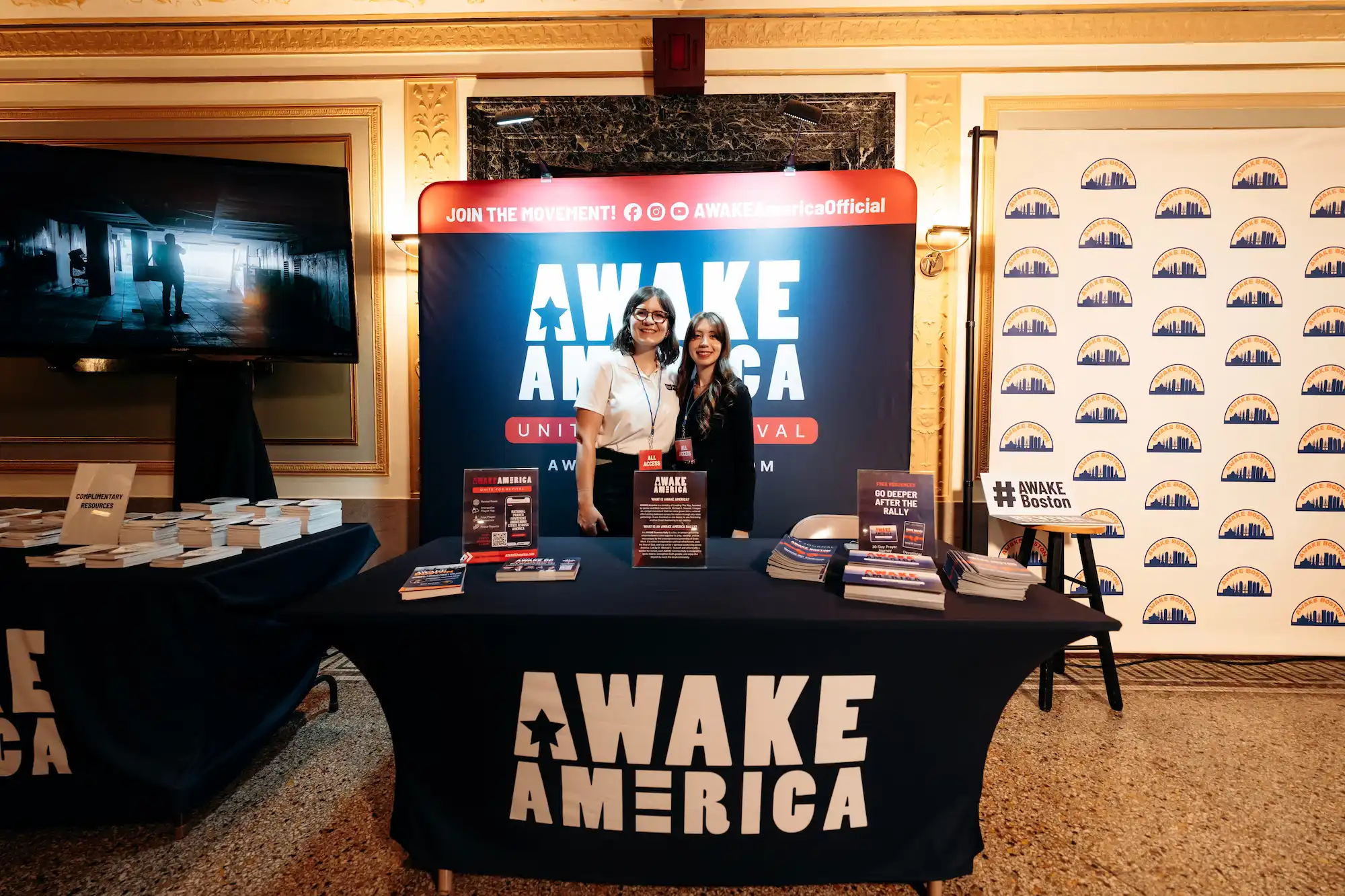 AWAKE America ministry booth with volunteers and literature at Boston rally