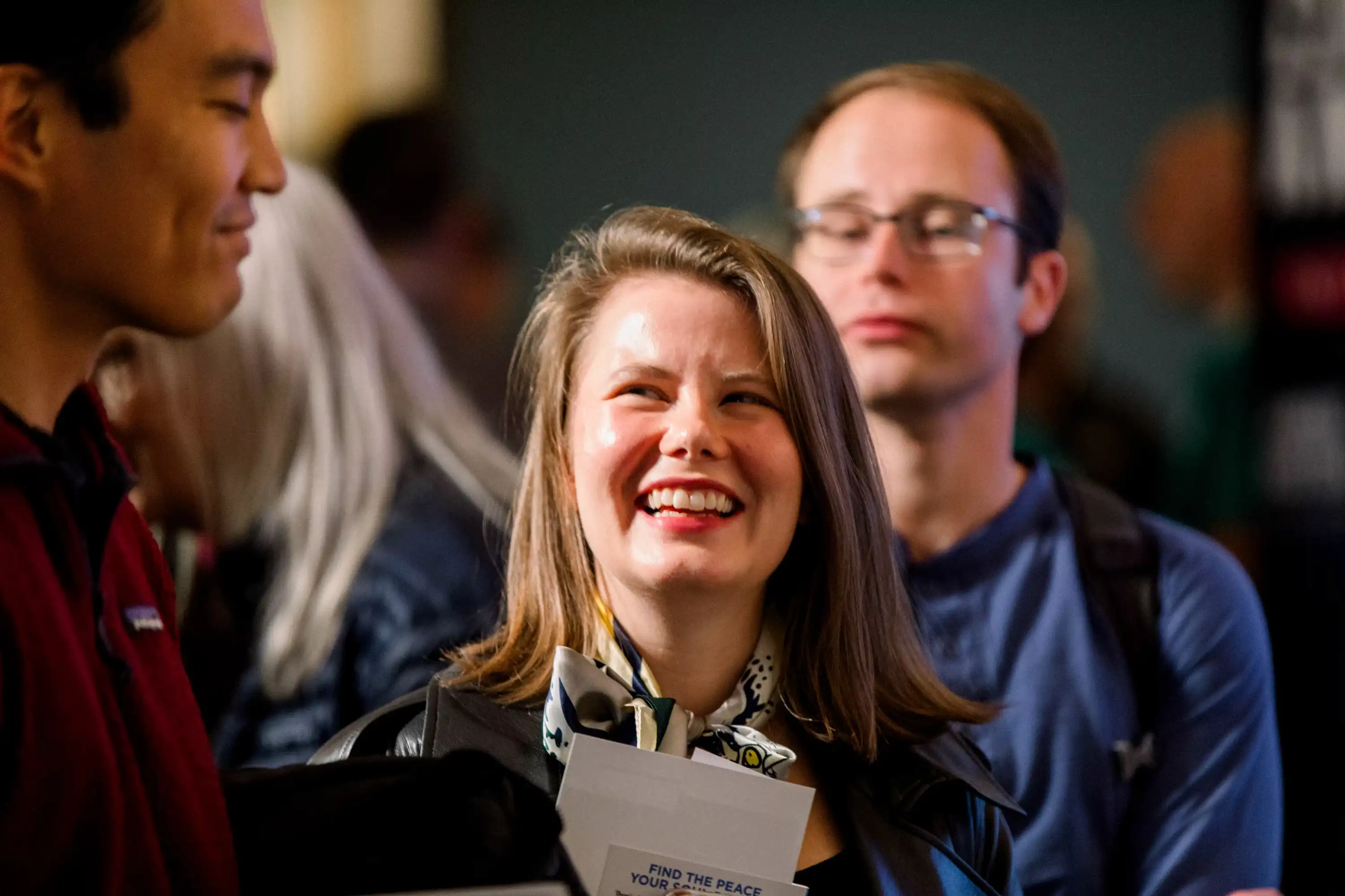 Joyful attendee laughing at AWAKE America Boston rally at Tremont Temple