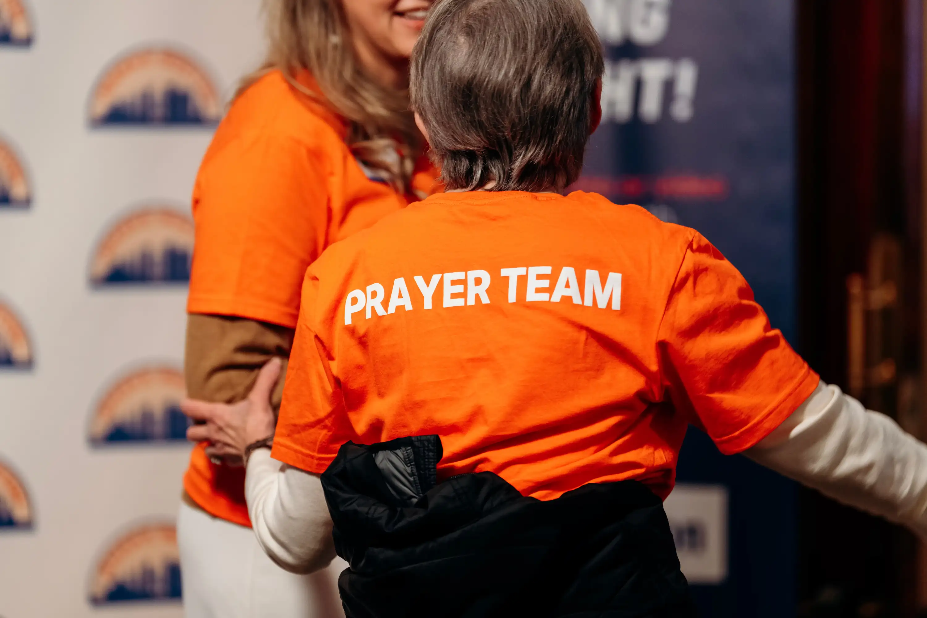 AWAKE America prayer team member being embraced at Boston rally