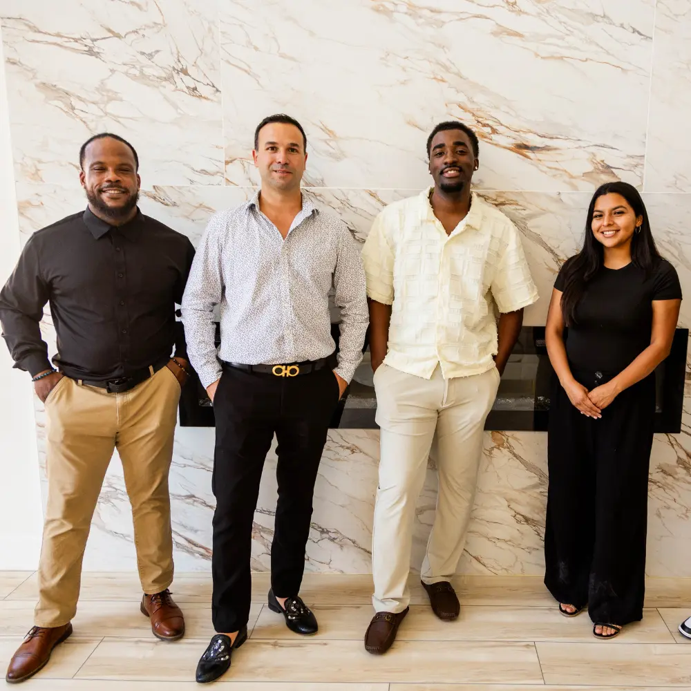 Vegas Home Buyers team standing together indoors, smiling for a company photo