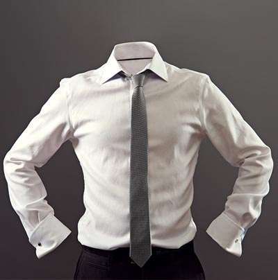 Headless figure wearing a white dress shirt and grey tie against a plain background