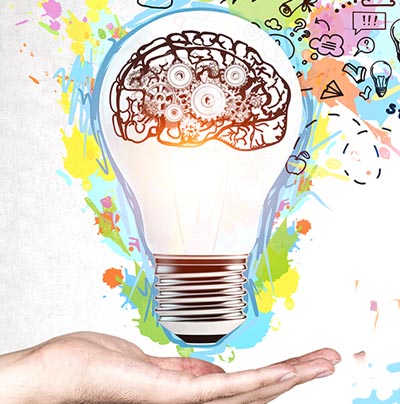 Colourful collage-style graphic with hand-drawn doodles of lightbulbs, clouds, paper planes, and creative icons emerging from a person’s hand, symbolising ideas. Bold, multi-coloured text in the foreground reads: ‘5 ideas for creative internal comms campaigns’ on a white concrete-textured background
