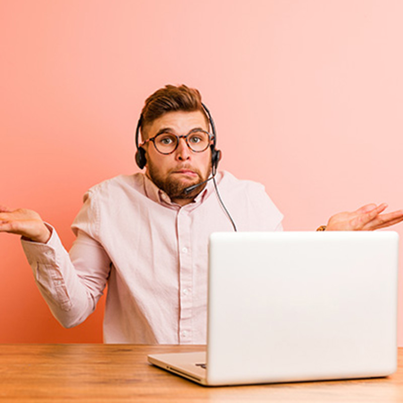 A cropped image of a worker at his laptop looking confused and indifferent because he does not understand or care about his employer's strategy