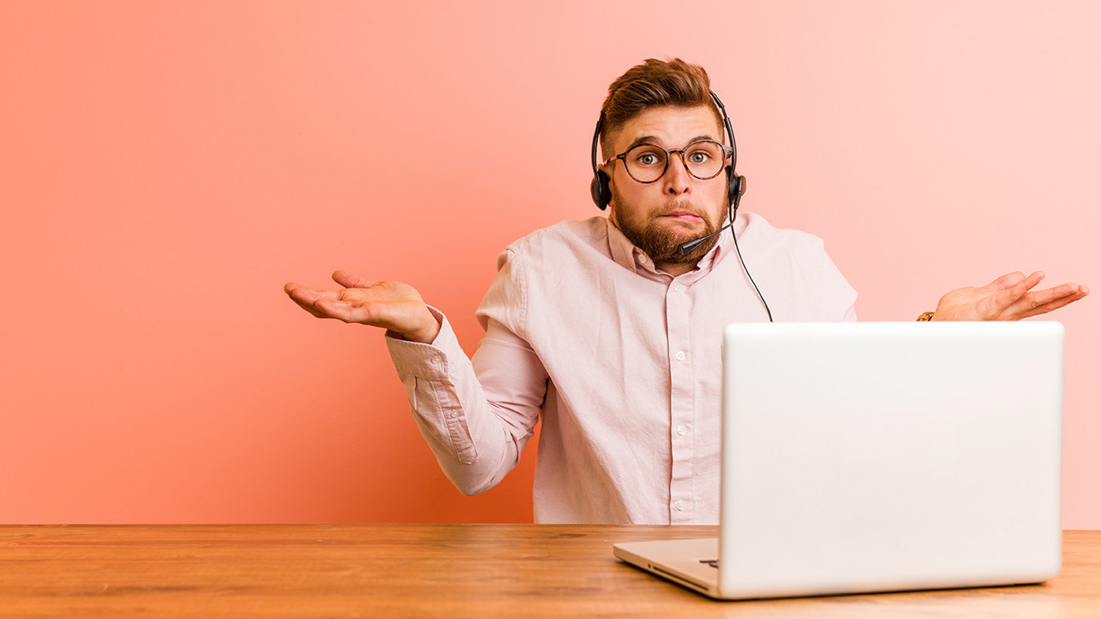 A worker at his laptop looking confused and indifferent because he does not understand or care about his employer's strategy