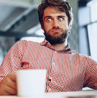 A photo of a manager looking confused and lost having not been given the information to support his staff with AI rollout and adoption