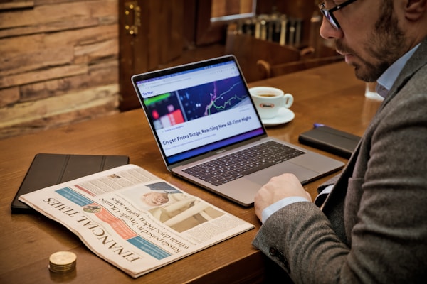 Sitting in a coffee shop checking Financial Times from the United Kingdom with cryptocurrency news aside.