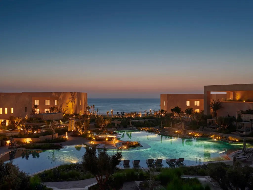 Ambiance sereine autour de la piscine d’un resort contemporain à Taghazout lors d’un programme signé INÜI Collection.