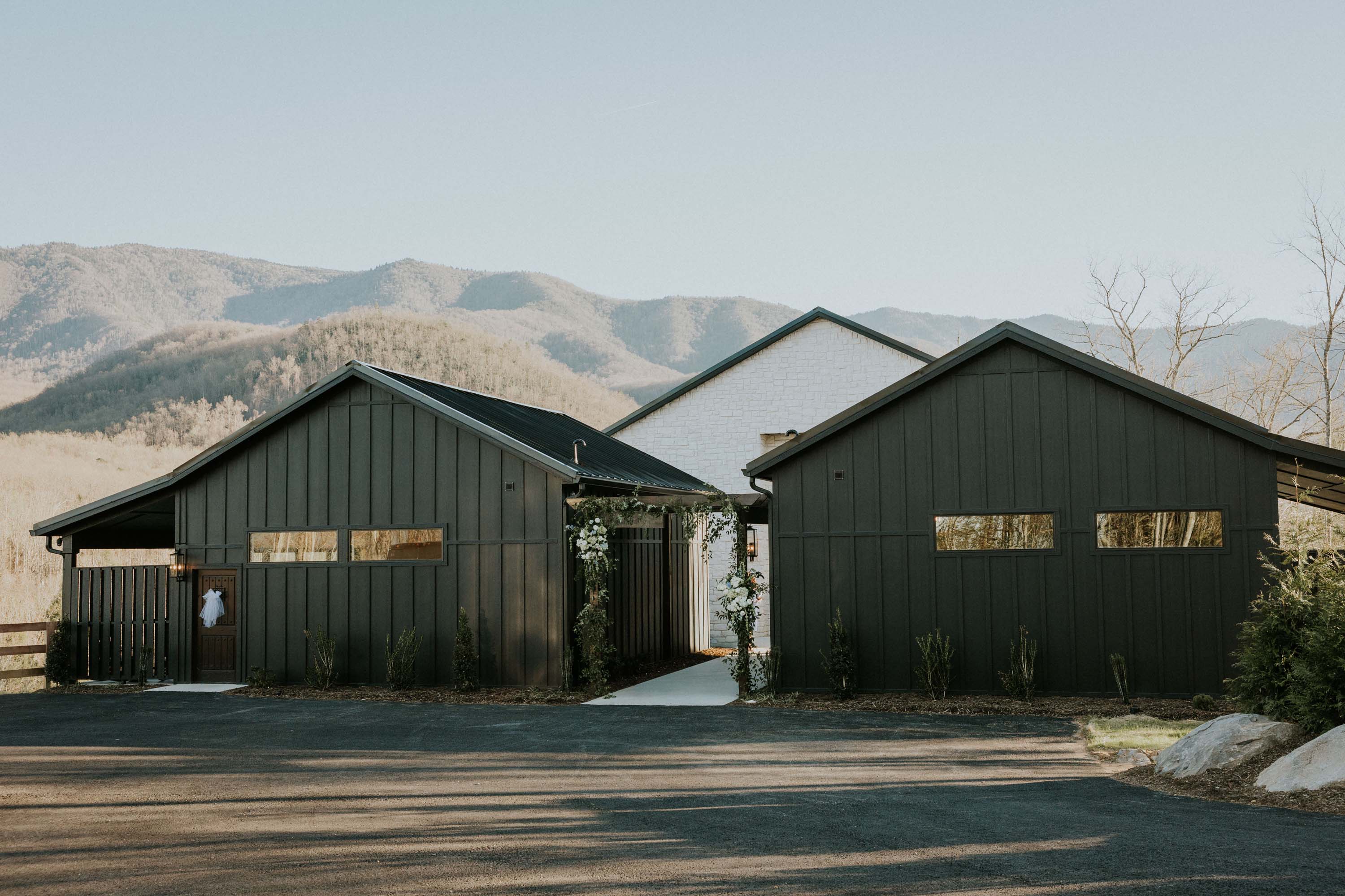 Trailhead Venues setting with dark and white modern buildings against rolling hills.