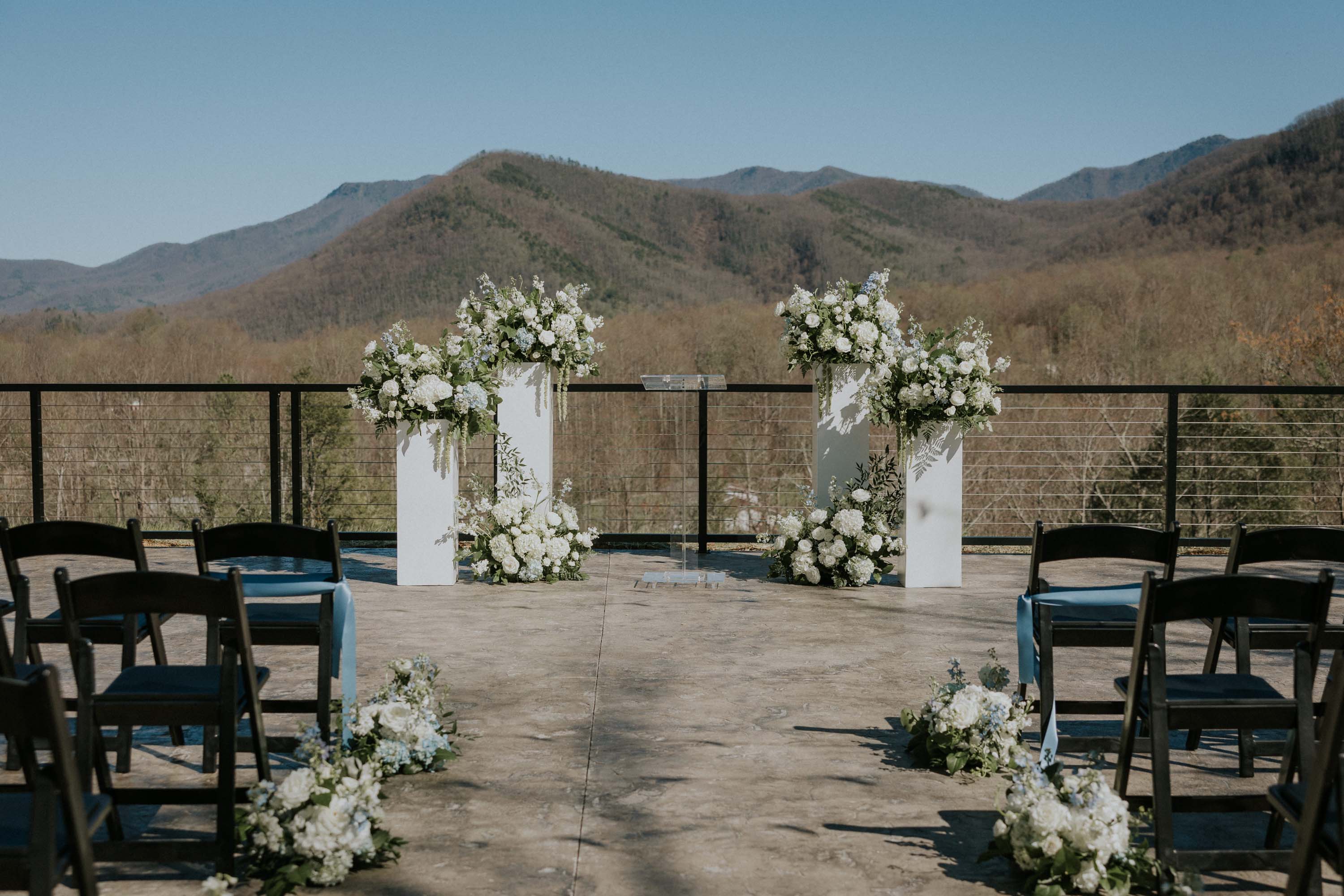 Outdoor wedding ceremony setup with floral arrangements overlooking mountains at Trailhead Venues.