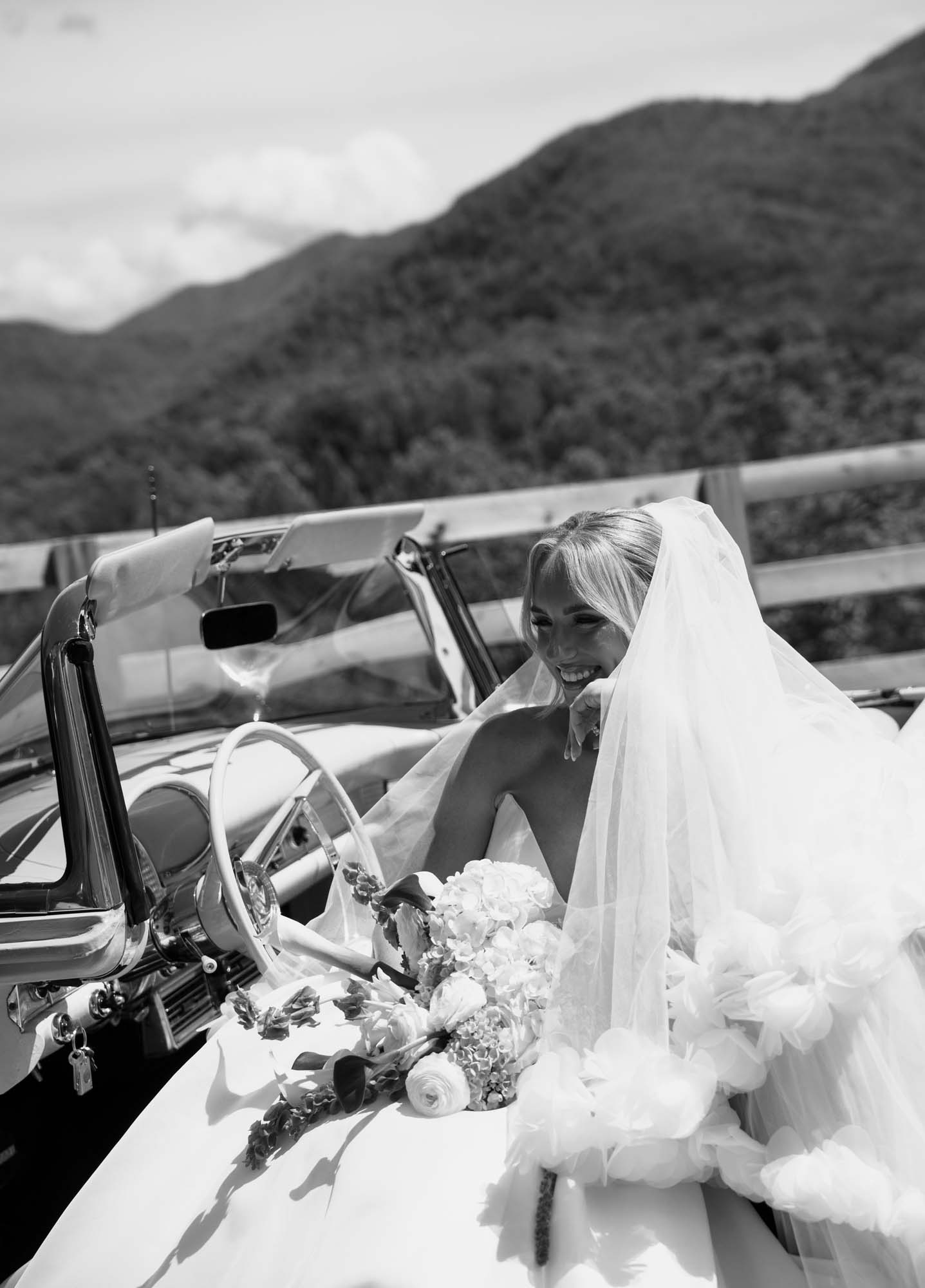 Bride in veil smiling with mountain backdrop at Trailhead Venues.