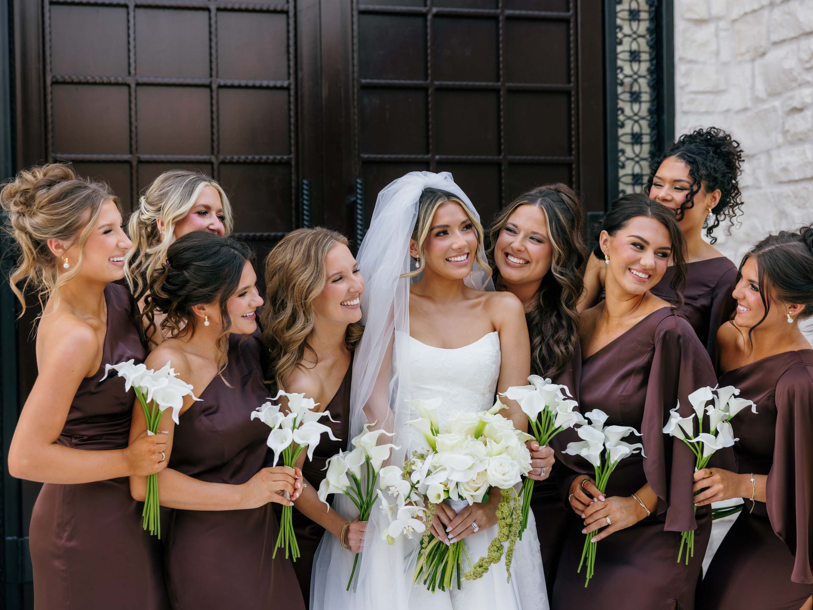 Bridal party posing before a dark door at a Gatlinburg wedding venue.