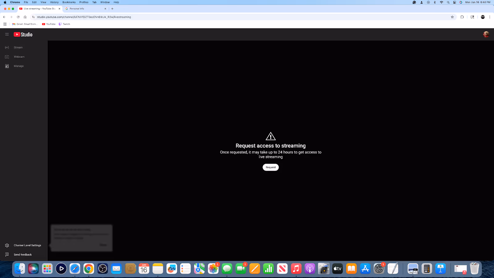 YouTube Studio dashboard showing a warning notification related to a channel strike on a laptop screen.