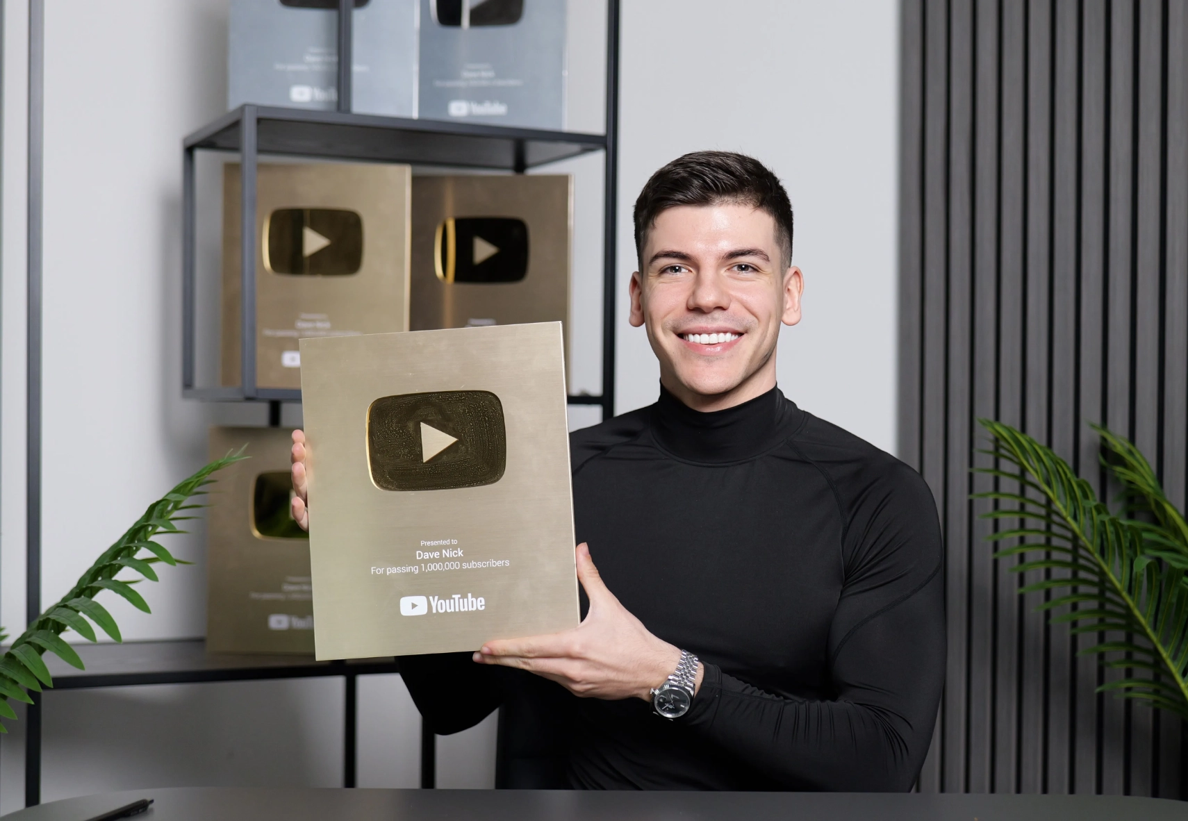 Dave Nick holding a YouTube 1 million subscriber play button