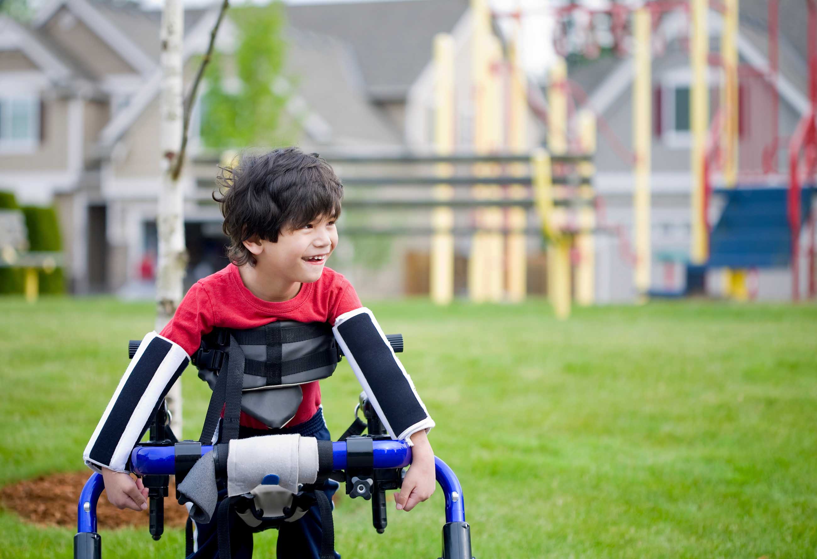 child with assistive technology in a field