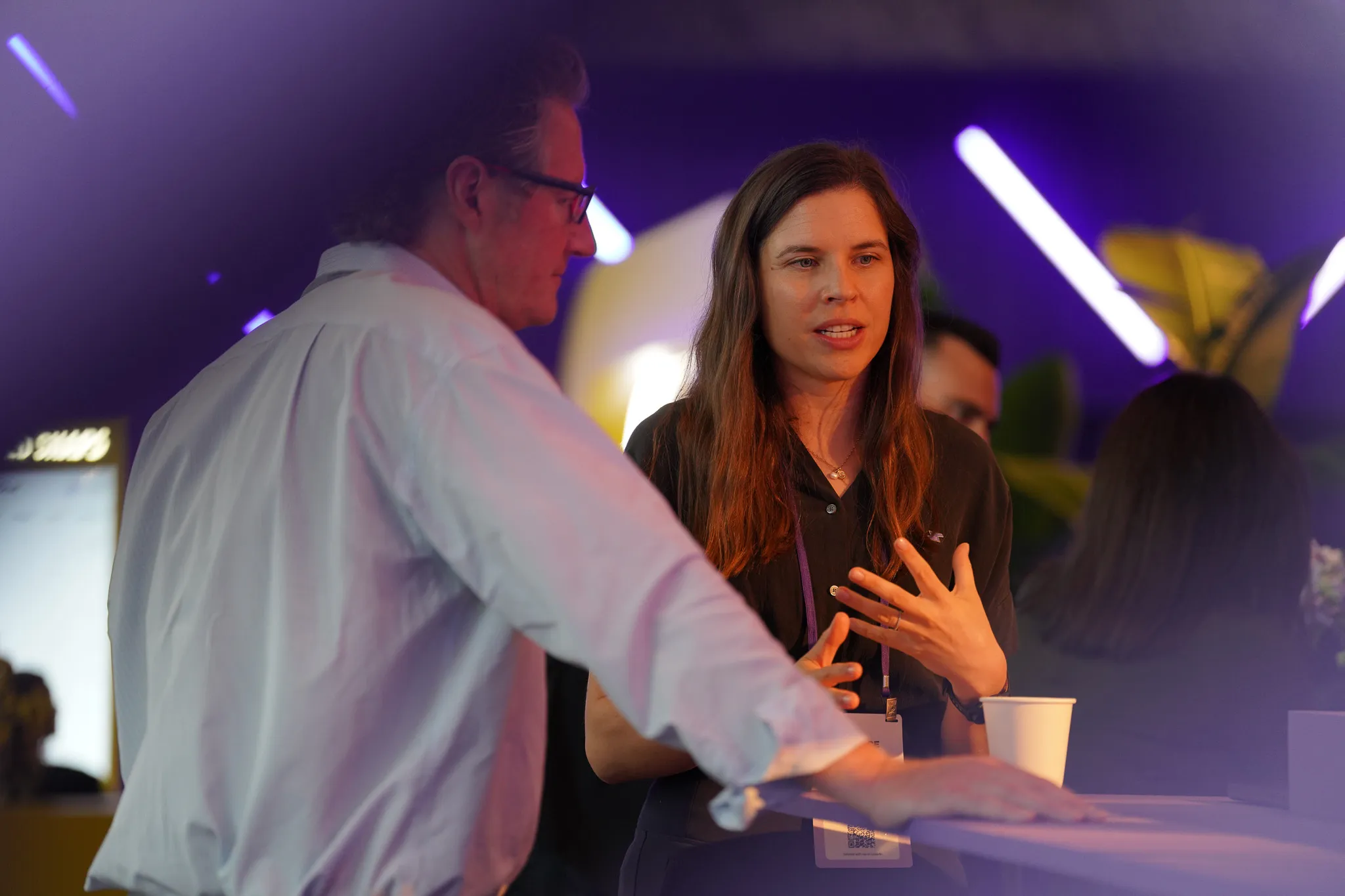 Panel discussion on stage about New York Times blending creativity and performance on Snapchat with three speakers.