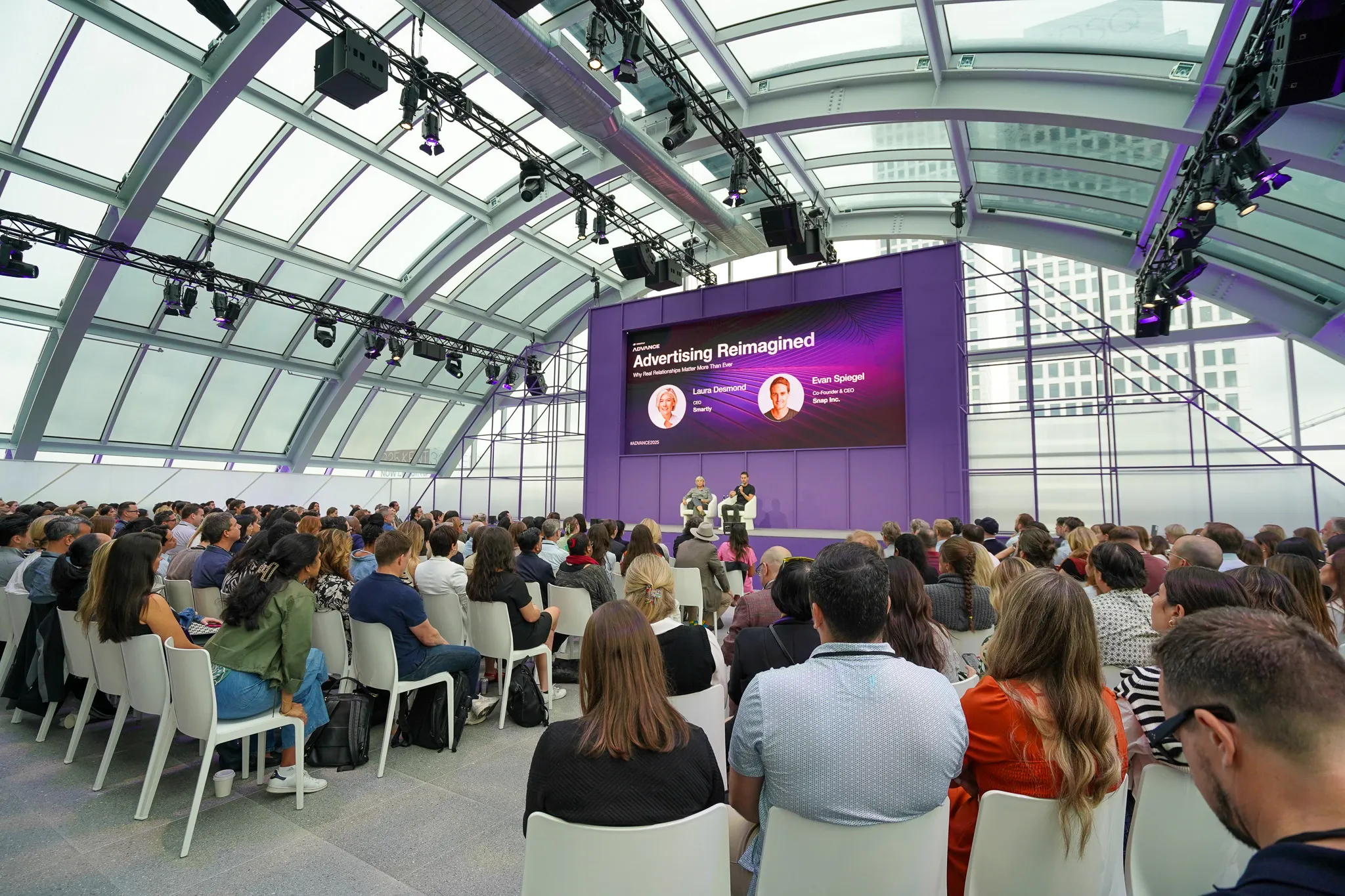 Panel discussion titled "Advertising for Good" featuring five speakers seated under a purple banner with logos.