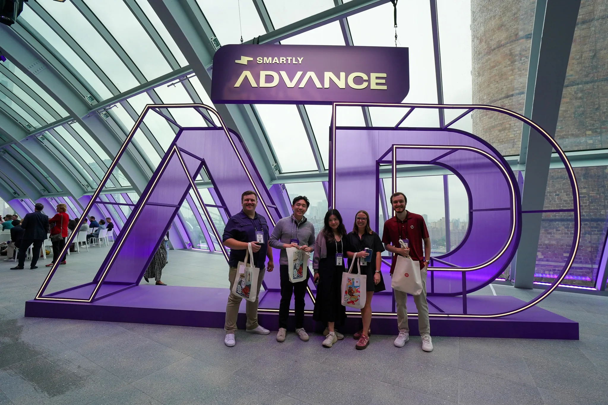 Panel discussion titled "Advertising Reimagined" with six speakers seated on white chairs in front of a large screen.