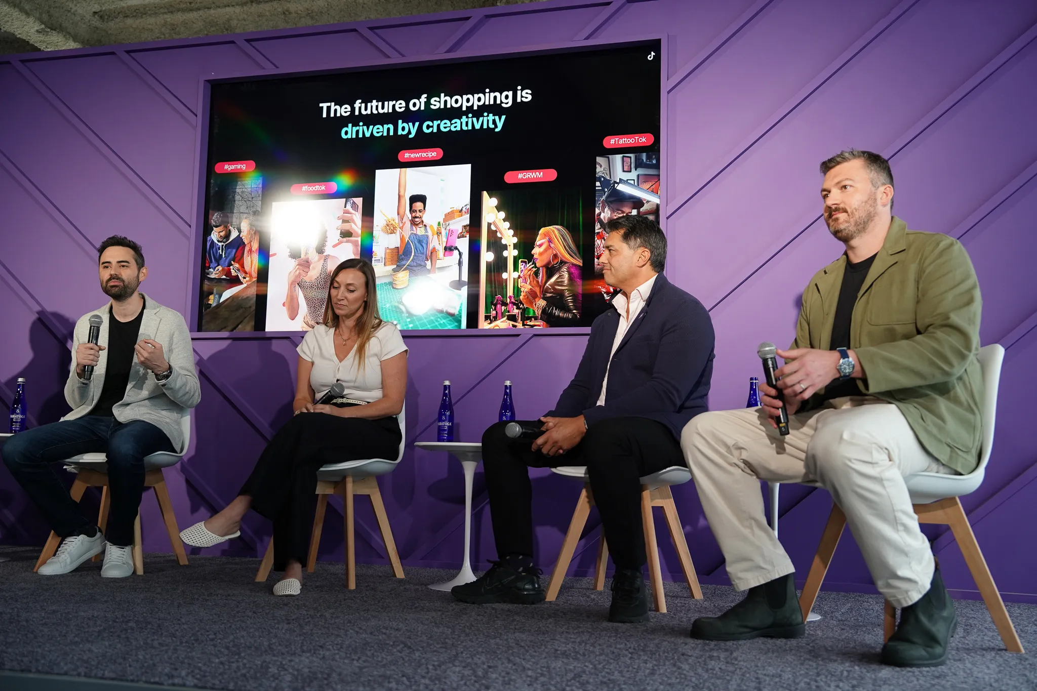 TikTok Bodega event booth with people chatting and products displayed under branded signage inside an industrial-style venue.