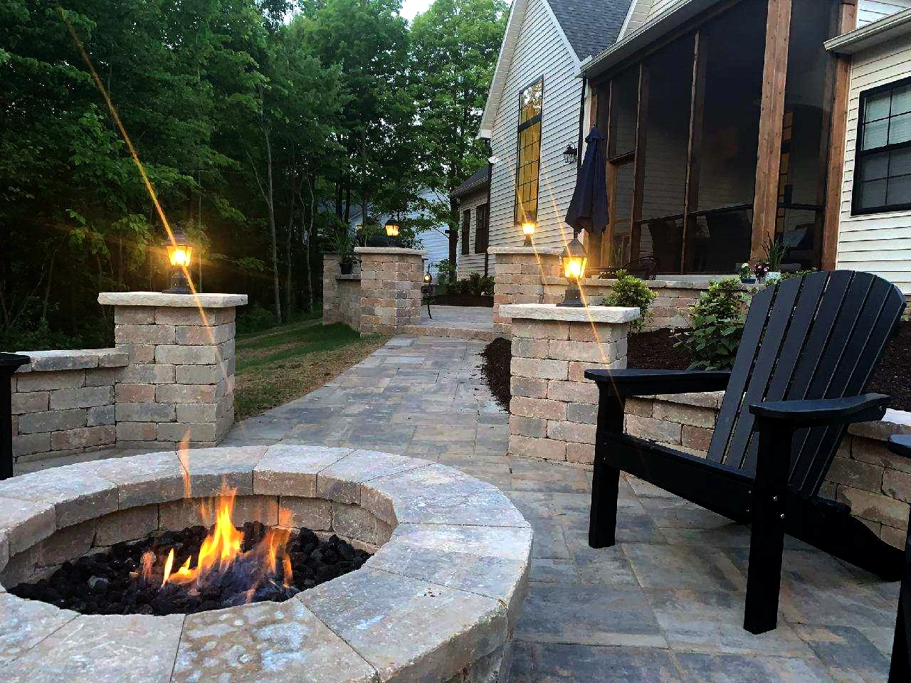 Fire Pits & Fireplaces: Custom outdoor stone fire pit and fireplace creating a warm backyard gathering space in Ohio