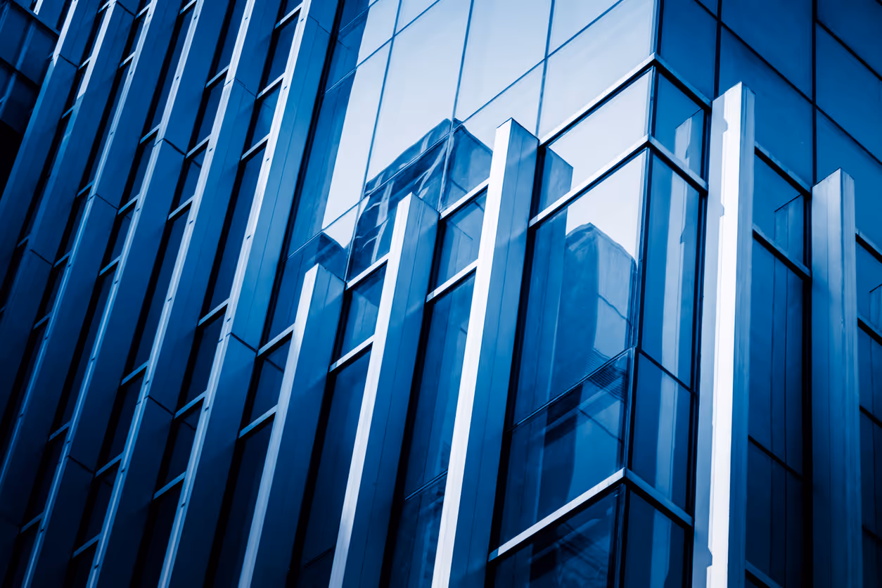 Modern blue glass skyscraper with geometric angular architectural design