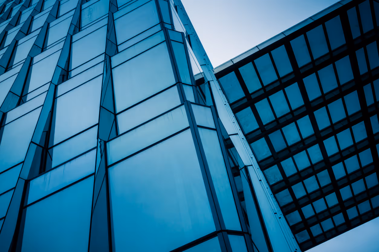 Modern glass office buildings with geometric blue-tinted windows